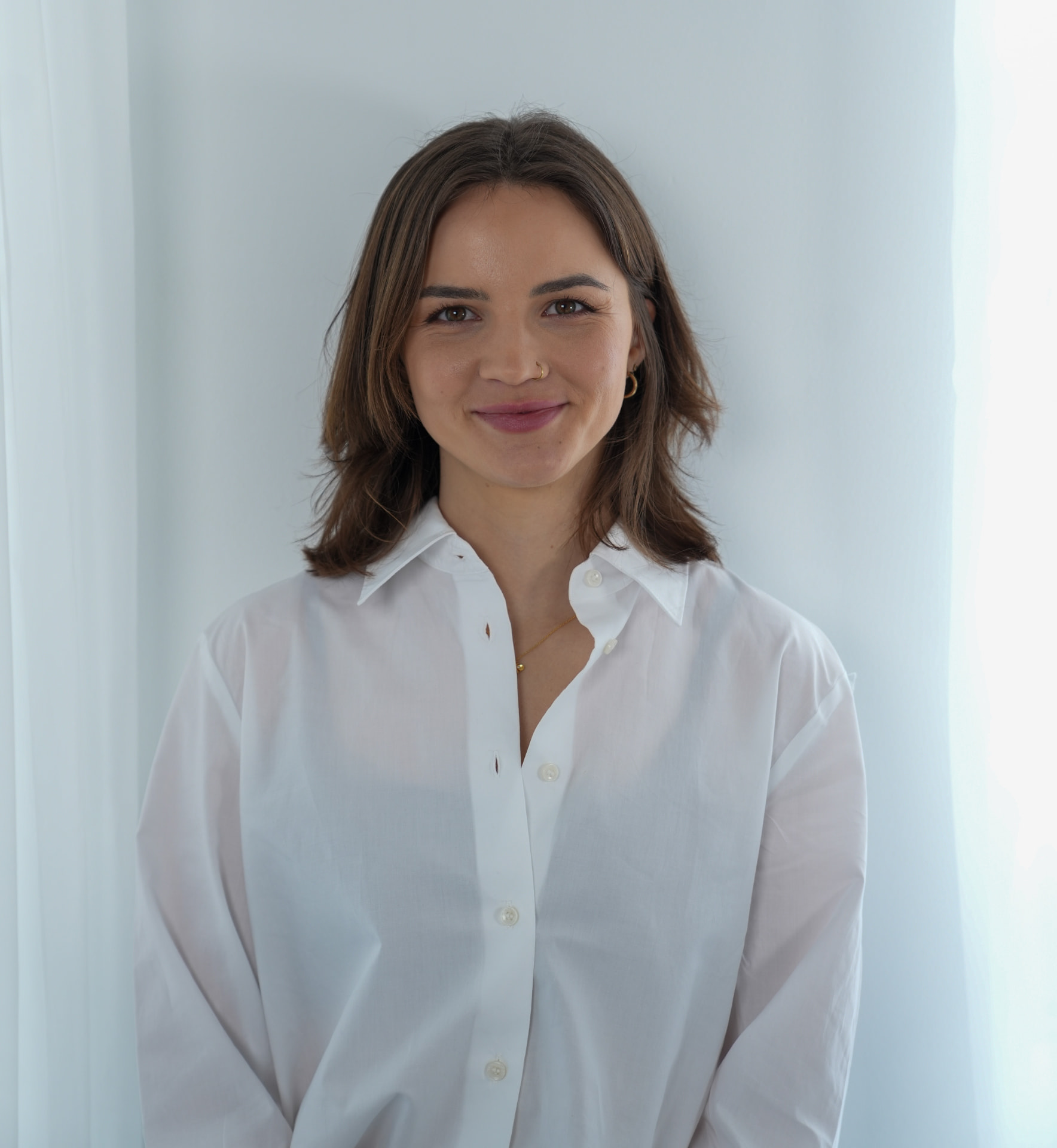 Sydona, TAS Practitioner, in a white shirt